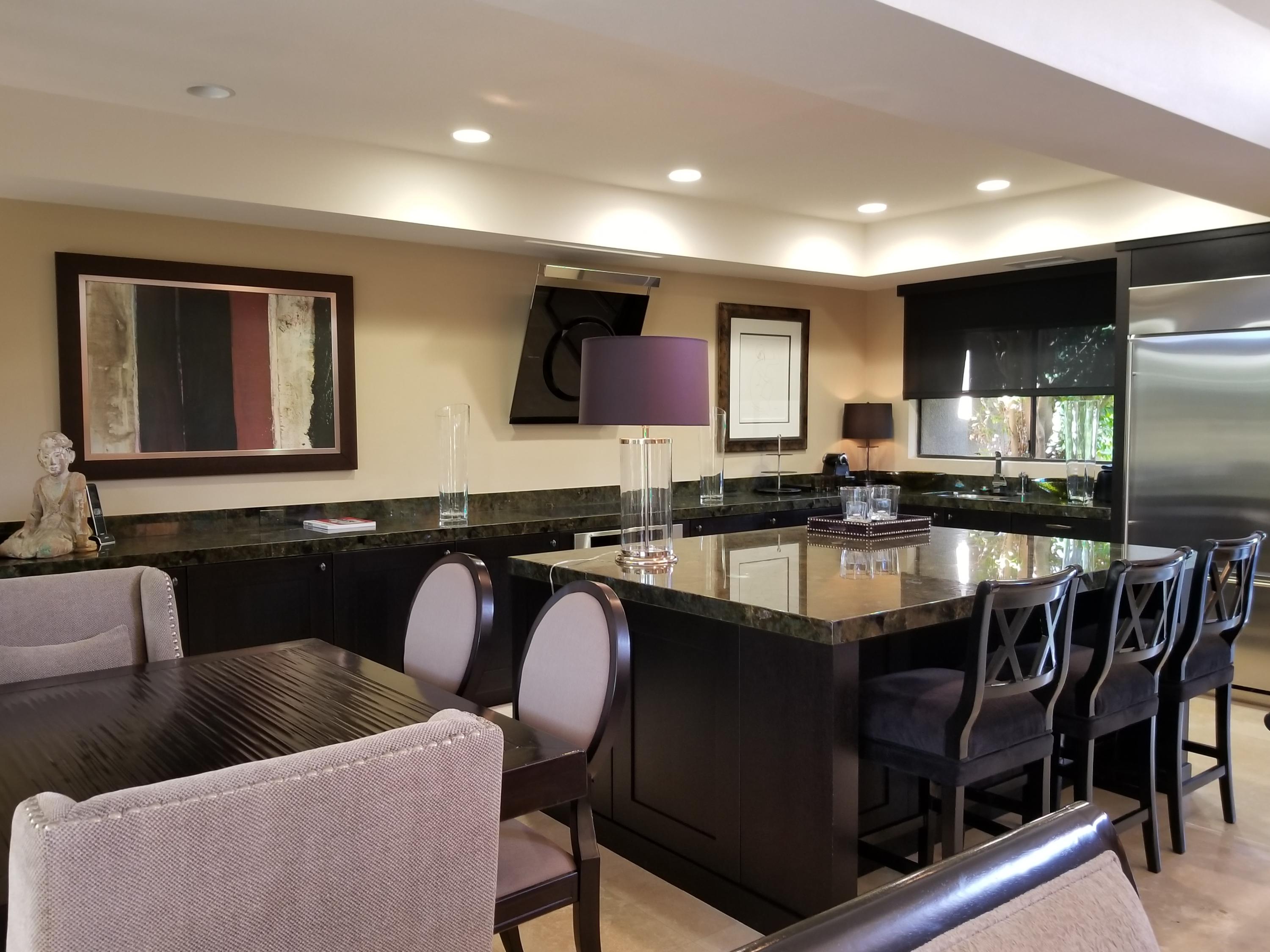 45735 Juniper Circle, Unit 522 Palm Desert, CA 92260 - Photo 13 of 53 a kitchen with stainless steel appliances granite countertop a refrigerator a sink a stove a dining table and chairs