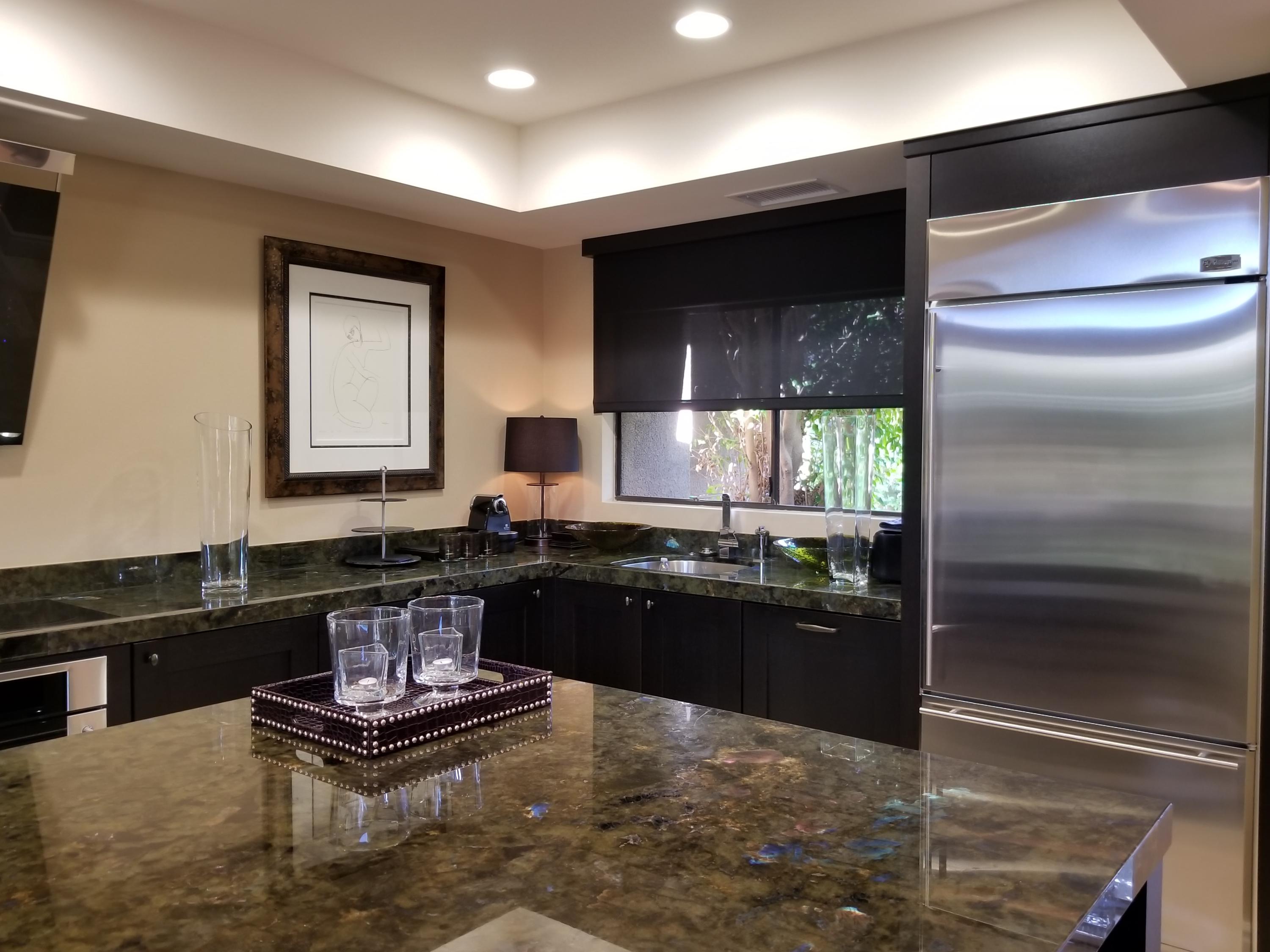 45735 Juniper Circle, Unit 522 Palm Desert, CA 92260 - Photo 14 of 53 a kitchen with kitchen island granite countertop stainless steel appliances and a counter top space