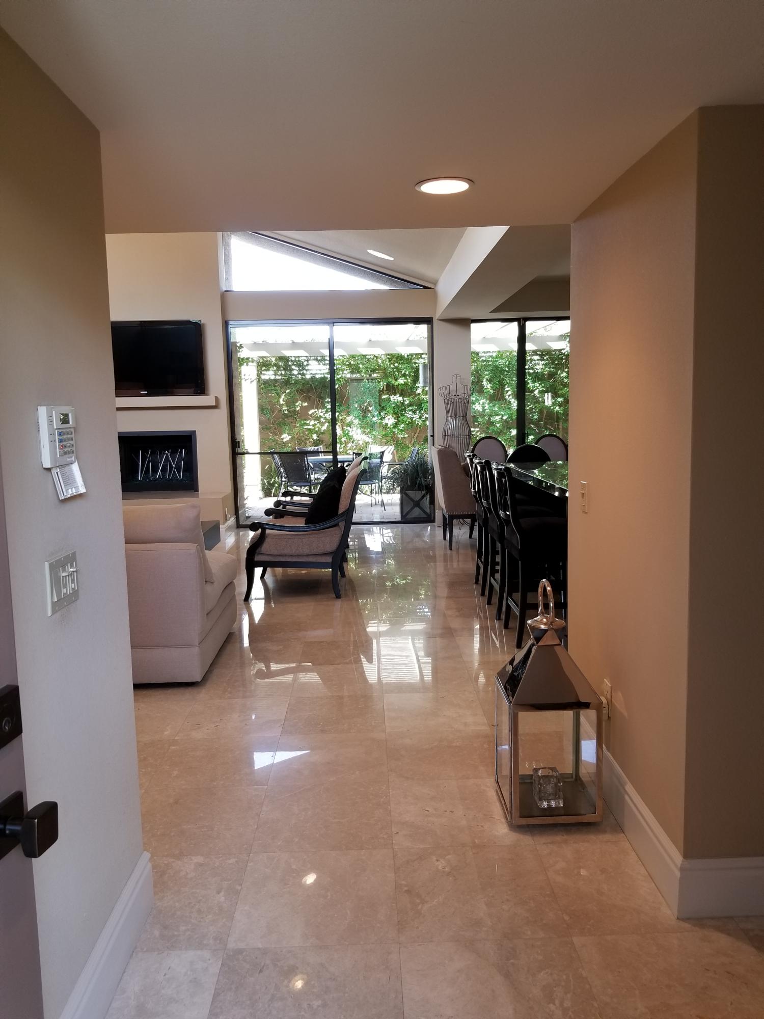45735 Juniper Circle, Unit 522 Palm Desert, CA 92260 - Photo 3 of 53 a living room with furniture tv and a large window