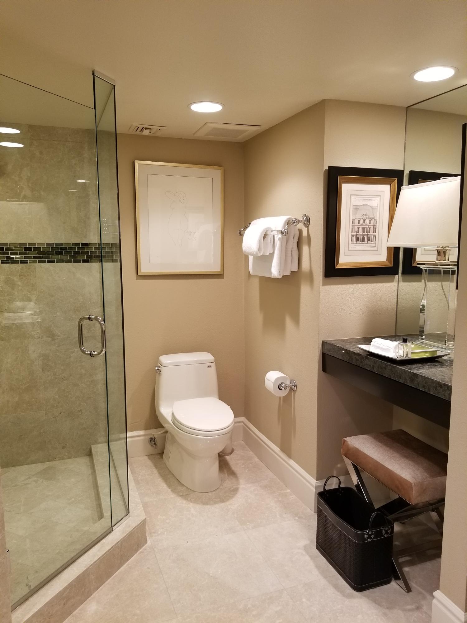 45735 Juniper Circle, Unit 522 Palm Desert, CA 92260 - Photo 21 of 53 a bathroom with a toilet a sink and mirror