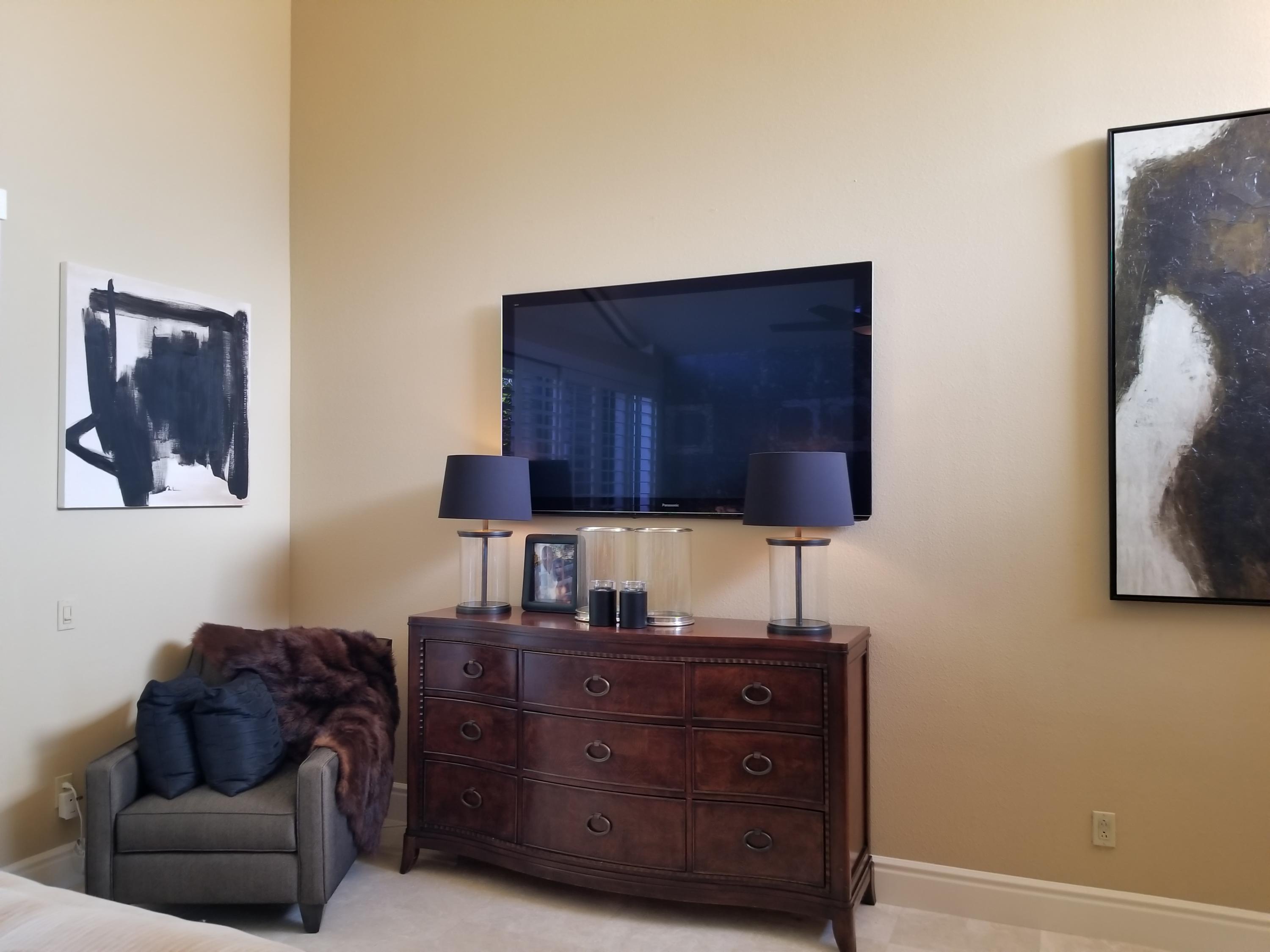 45735 Juniper Circle, Unit 522 Palm Desert, CA 92260 - Photo 35 of 53 a room with furniture and a flat screen tv