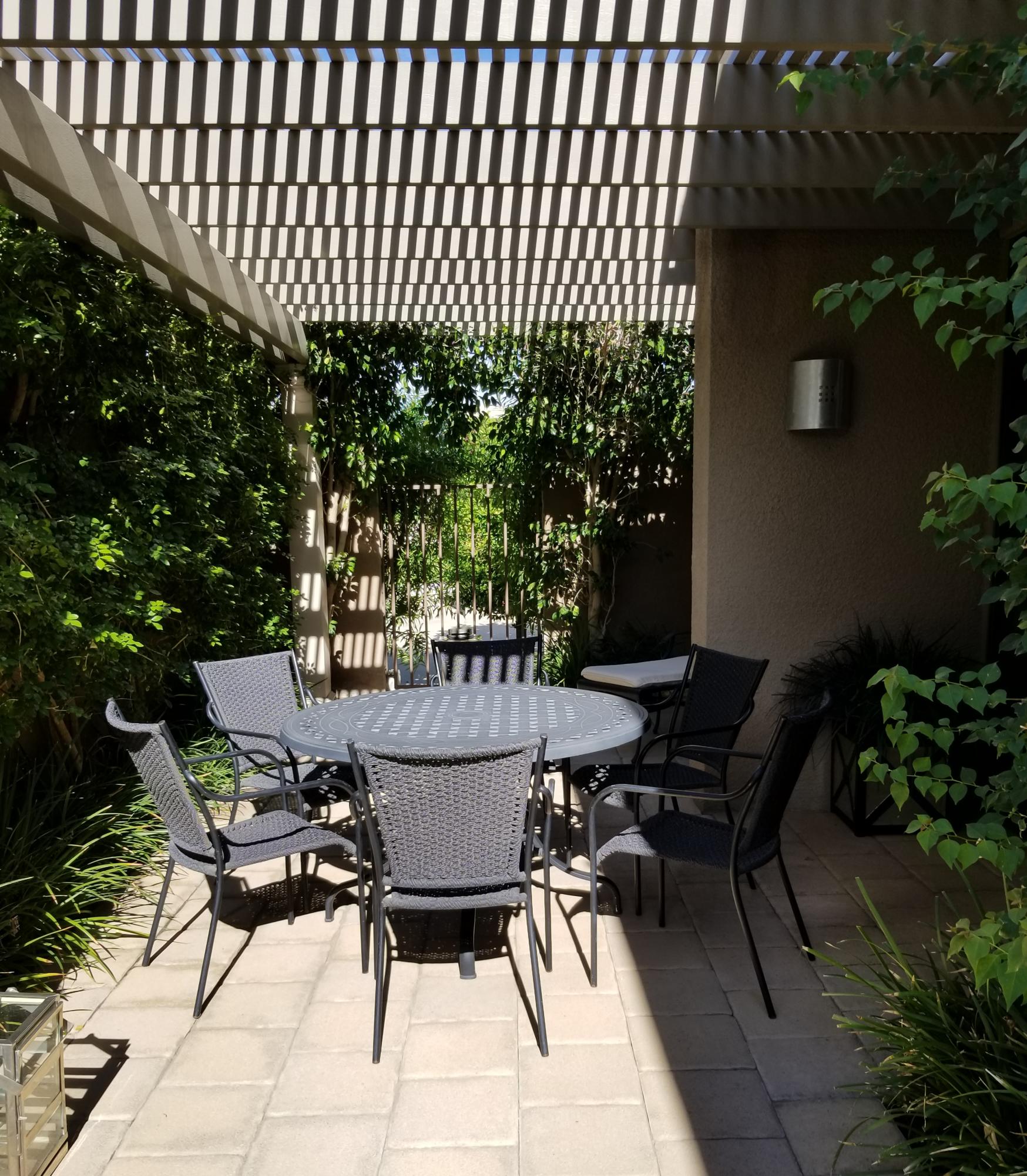 45735 Juniper Circle, Unit 522 Palm Desert, CA 92260 - Photo 40 of 53 a patio with table and chairs and potted plants