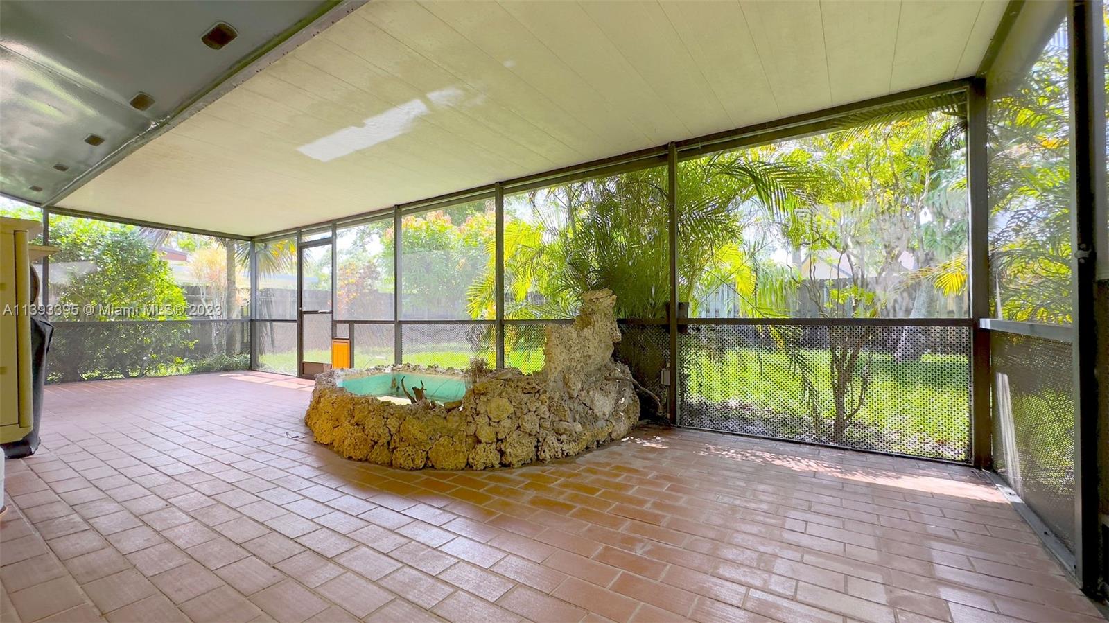 11412 Southwest 113th Place Miami, FL 33176 - Photo 11 of 16 a view of porch and garden