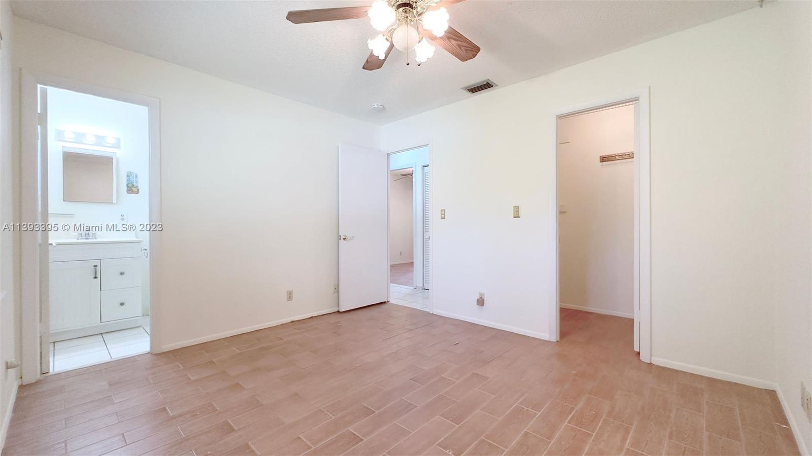11412 Southwest 113th Place Miami, FL 33176 - Photo 12 of 16 wooden floor in an empty room with a window