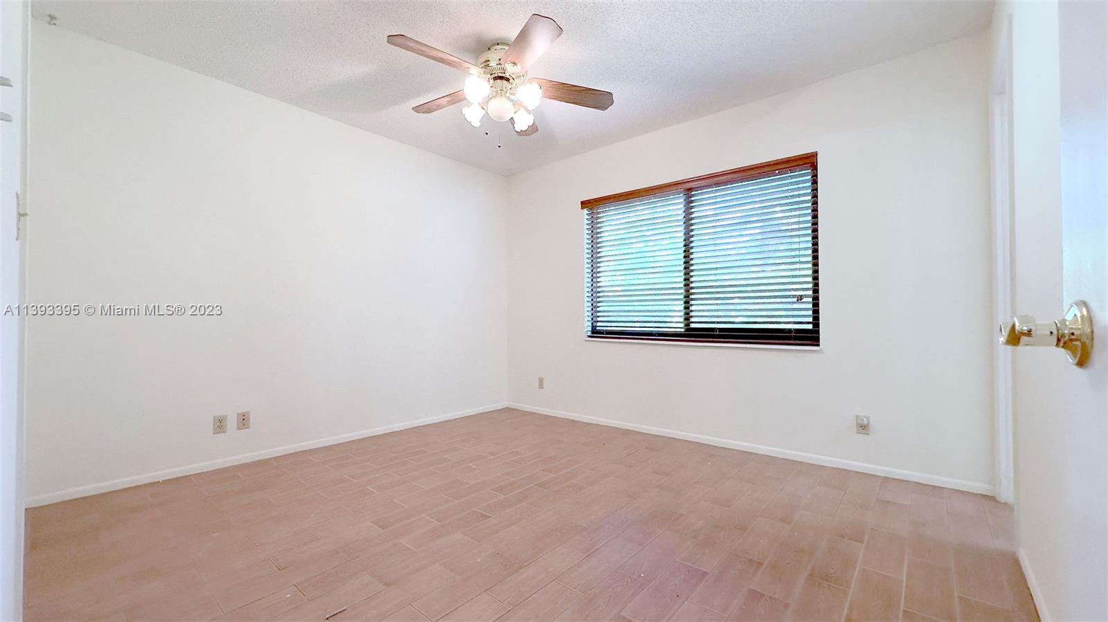 11412 Southwest 113th Place Miami, FL 33176 - Photo 15 of 16 an empty room with windows and fan
