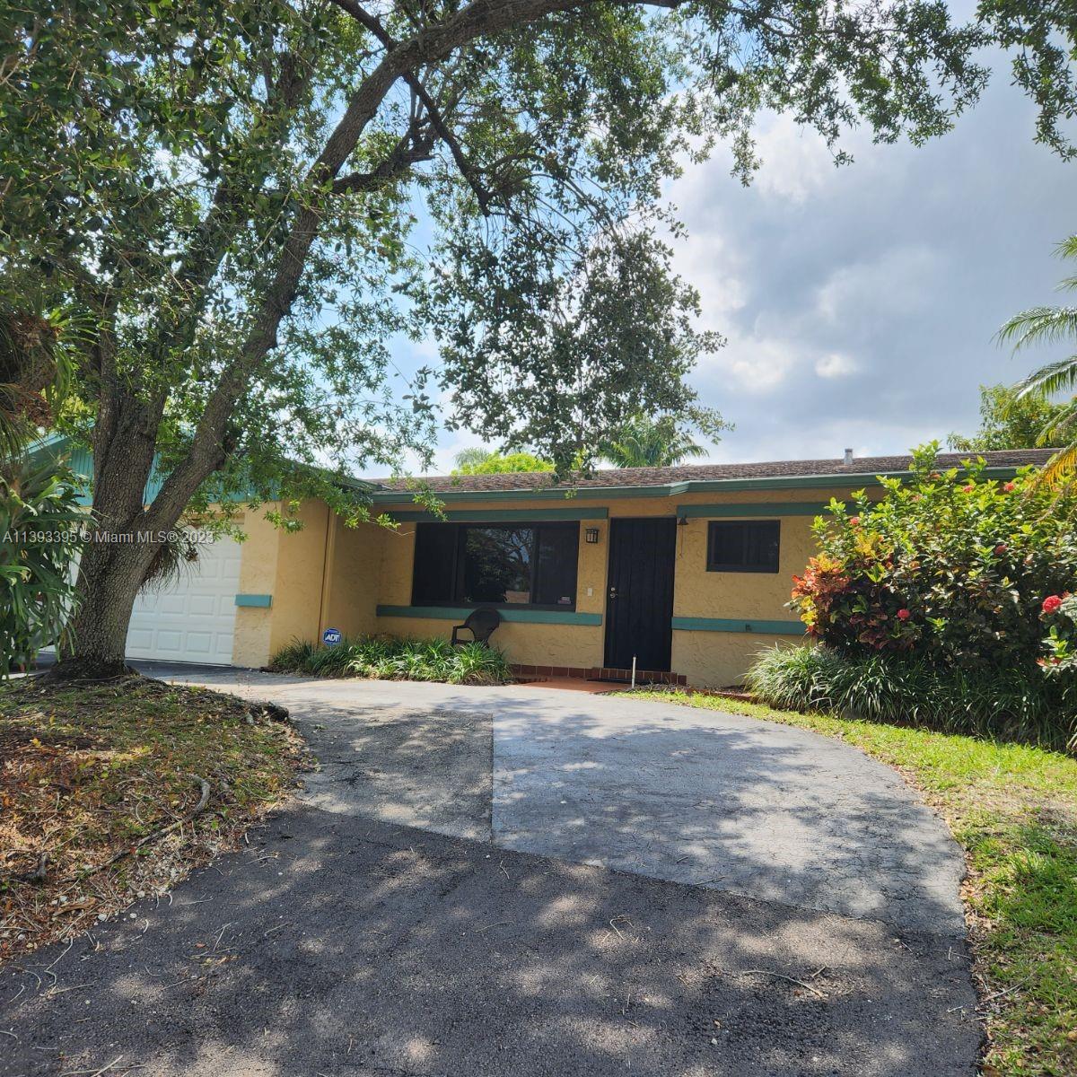 11412 Southwest 113th Place Miami, FL 33176 - Photo 2 of 16 a view of a house with a yard and large tree