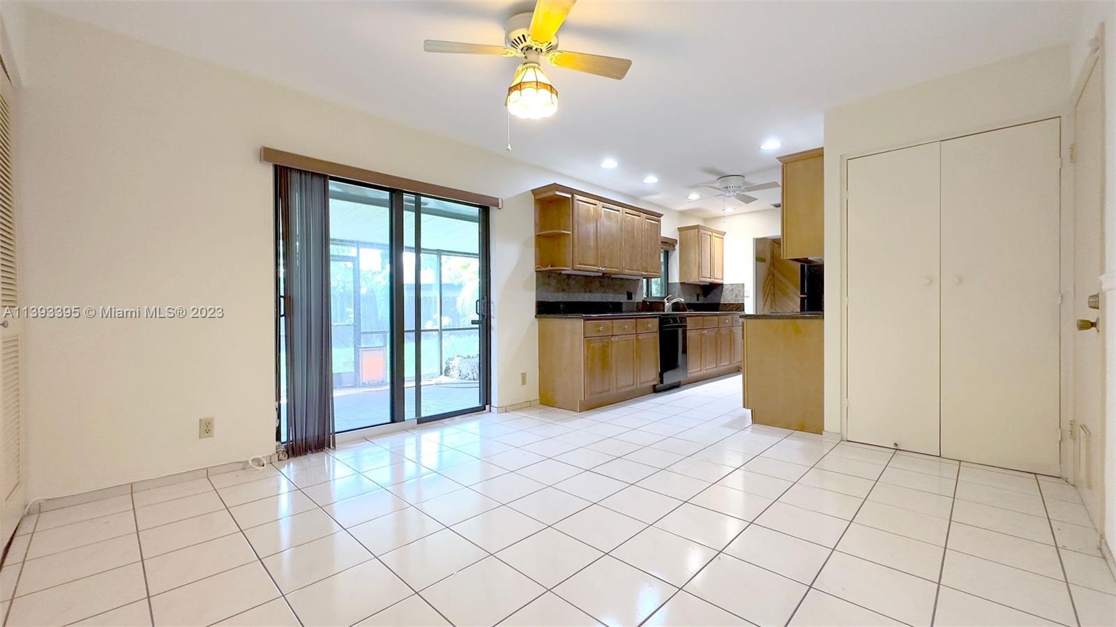 11412 Southwest 113th Place Miami, FL 33176 - Photo 7 of 16 a view of a kitchen with kitchen island granite countertop a refrigerator cabinets and a sink