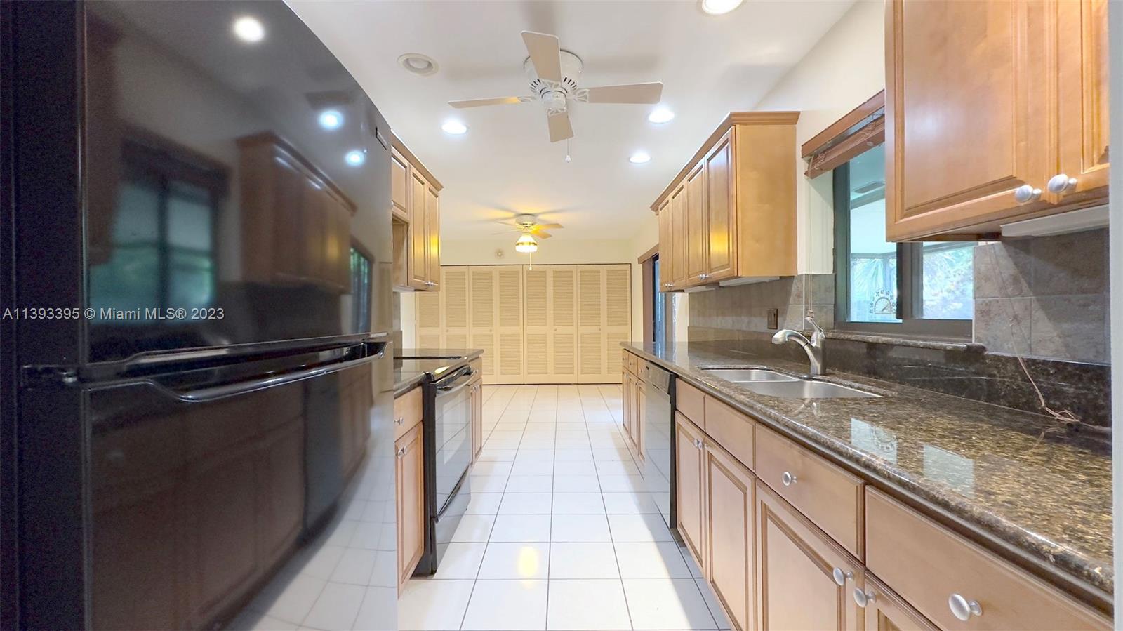 11412 Southwest 113th Place Miami, FL 33176 - Photo 9 of 16 a view of a kitchen with a sink and cabinets