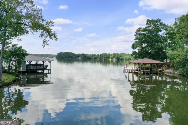 a view of a hallway with wooden floor and a chandelier