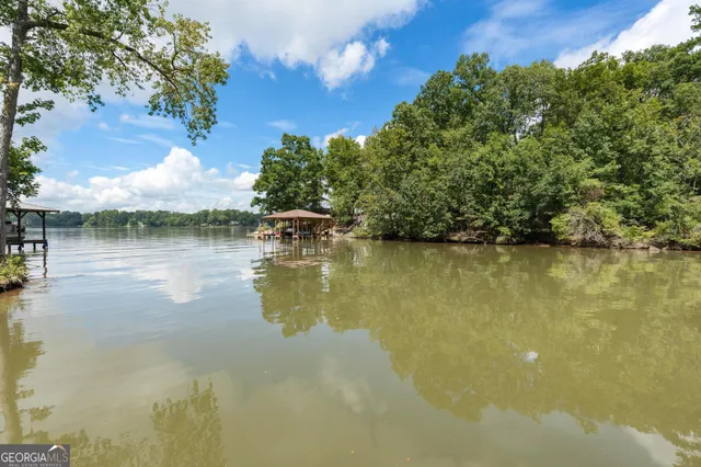 a kitchen with stainless steel appliances granite countertop a stove a sink dishwasher and a microwave oven with cabinets
