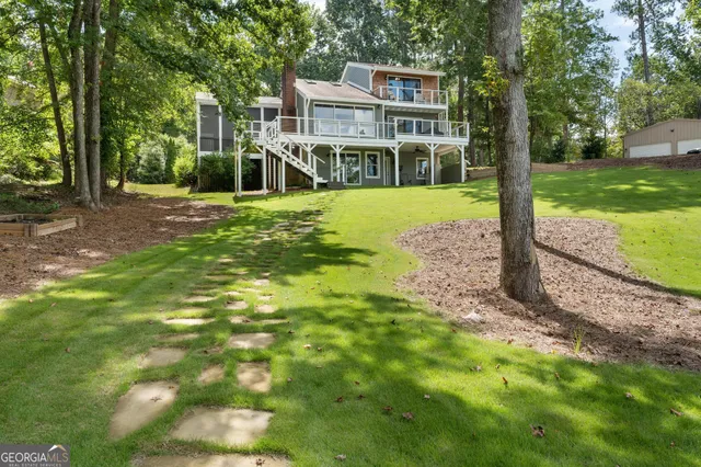 a kitchen with stainless steel appliances granite countertop a sink a stove and cabinets