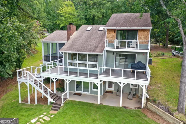 a kitchen with granite countertop white cabinets and a large window