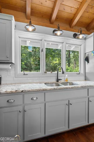 a bedroom with a bed tv and a window