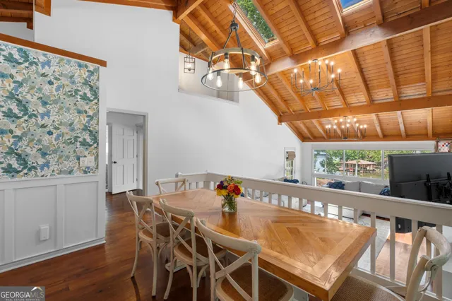 a bedroom with a large bed and a large window with balcony view