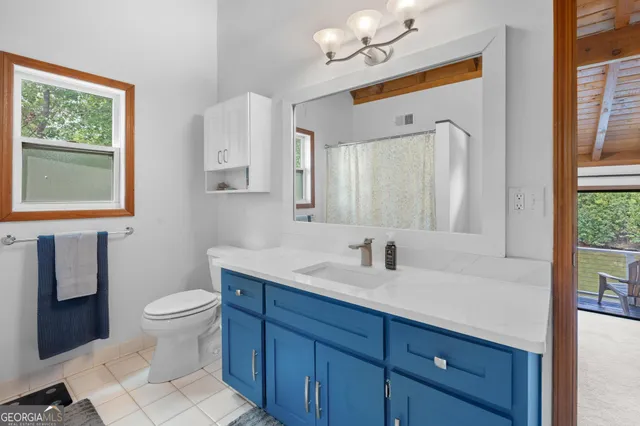 a bathroom with a sink a toilet a mirror and vanity