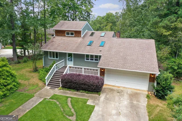 an aerial view of a house with a yard and garden