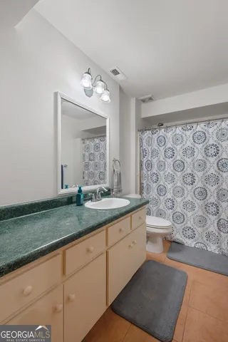 a balcony with wooden floor table and chairs