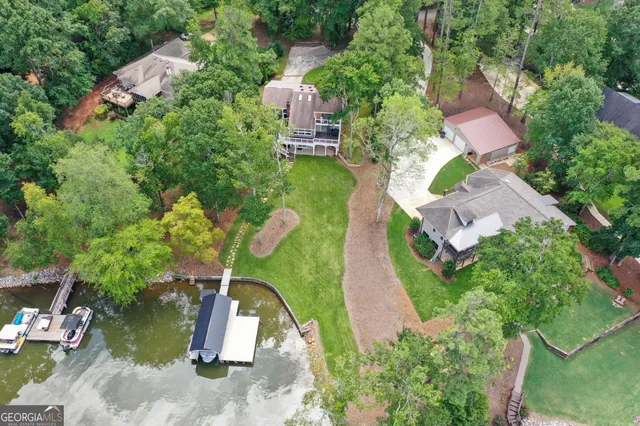 a view of a patio with table and chairs with wooden floor and fence