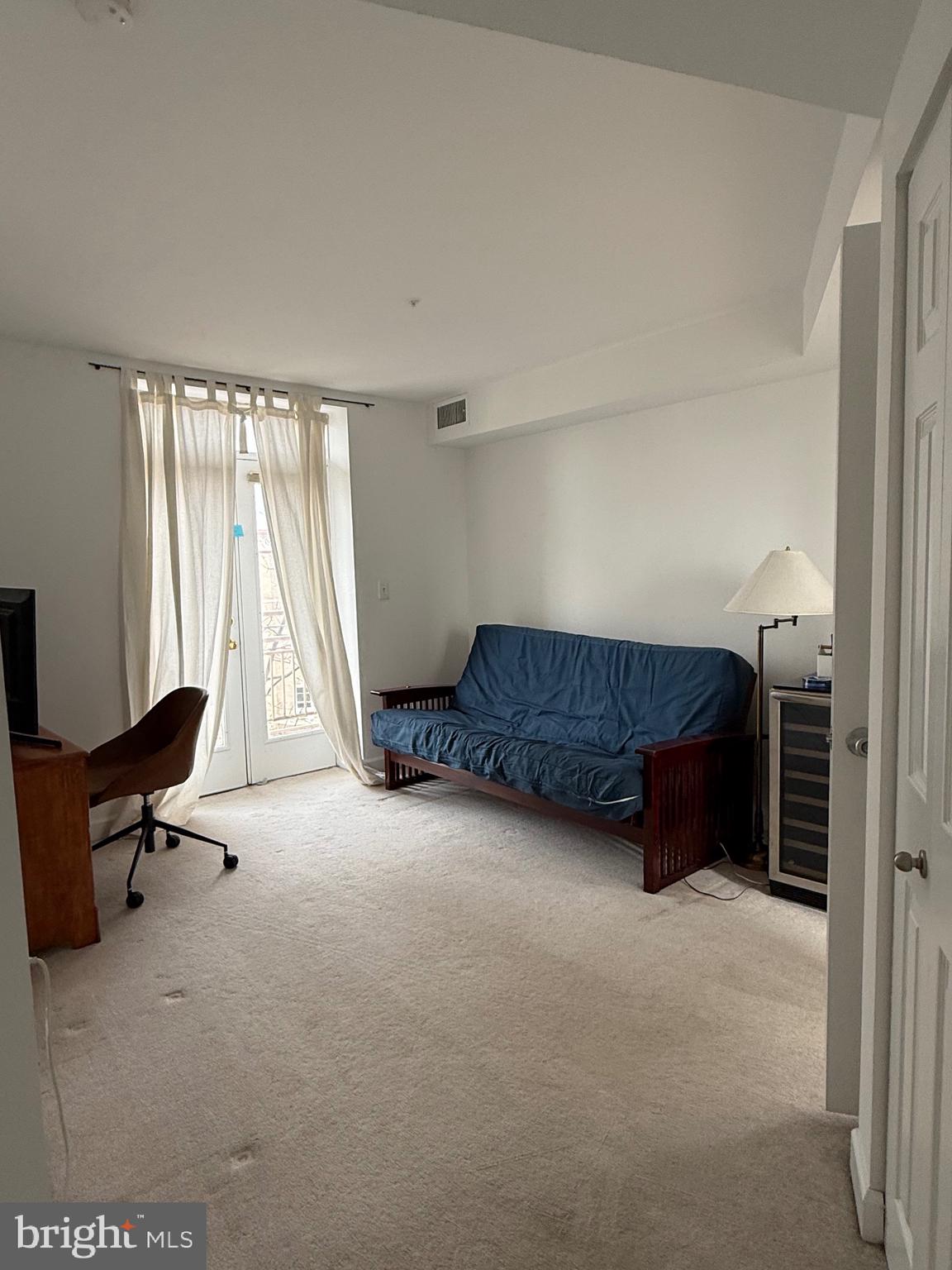 1801 Calvert Street Northwest, Unit 401 Washington, DC 20009 - Photo 11 of 23 a living room with furniture and a large window