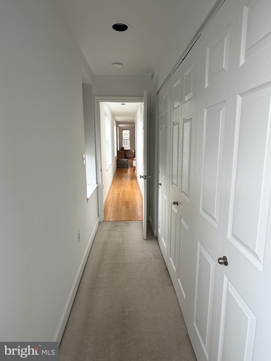 1801 Calvert Street Northwest, Unit 401 Washington, DC 20009 - Photo 12 of 23 a view of a hallway with wooden floor and closet area