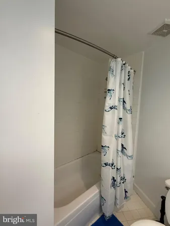 a bathroom with a bathtub and shower