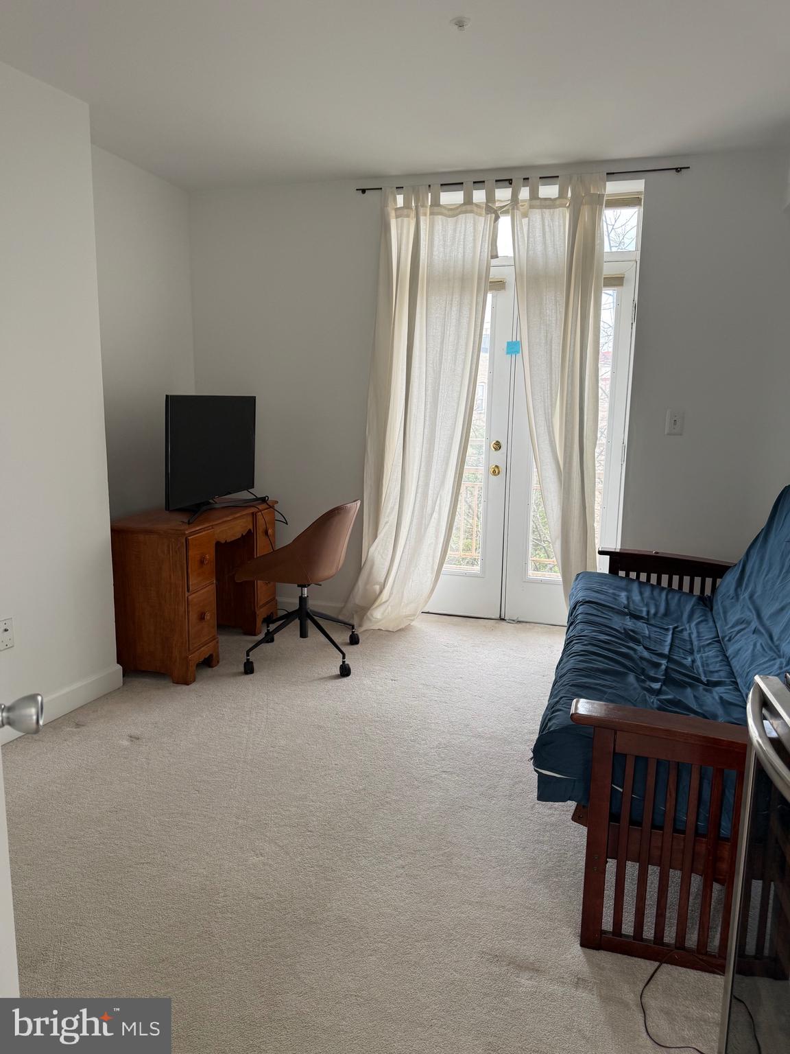 1801 Calvert Street Northwest, Unit 401 Washington, DC 20009 - Photo 17 of 23 a room with furniture and a flat screen tv