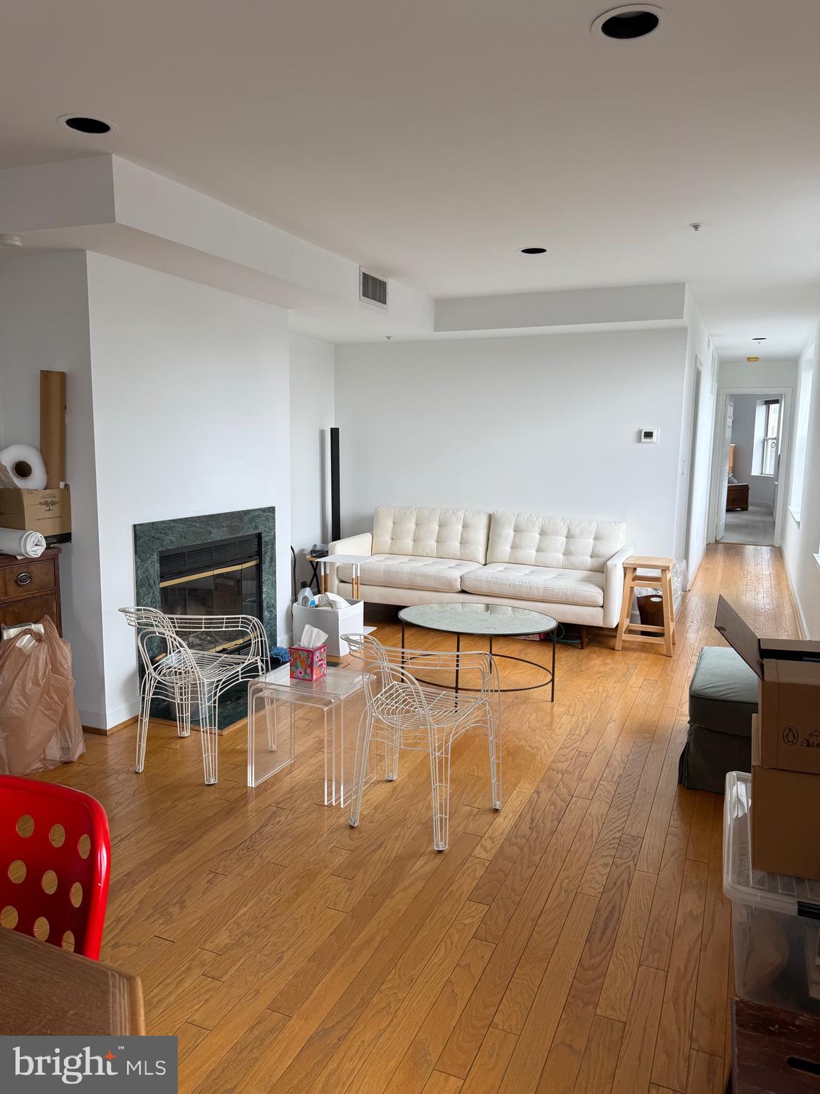1801 Calvert Street Northwest, Unit 401 Washington, DC 20009 - Photo 20 of 23 a living room with furniture and a fireplace