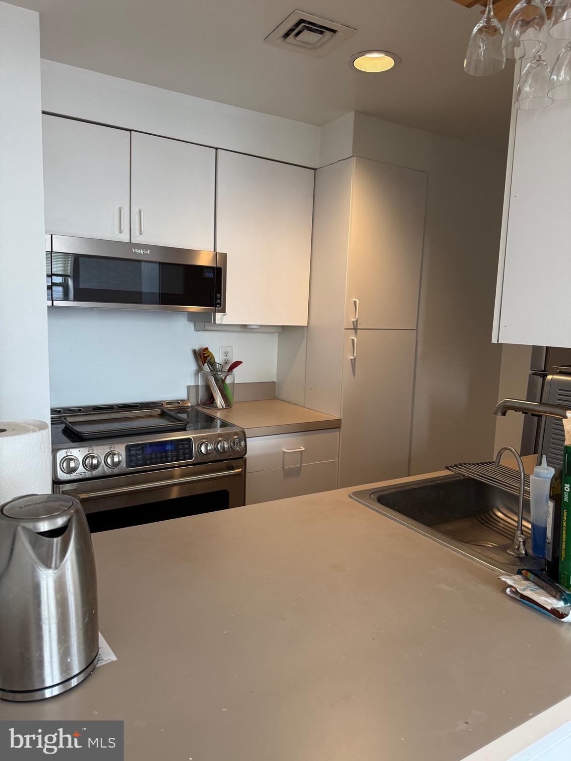 1801 Calvert Street Northwest, Unit 401 Washington, DC 20009 - Photo 23 of 23 a kitchen with a stove and a sink