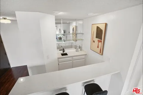 a kitchen with stainless steel appliances a refrigerator and a stove top oven