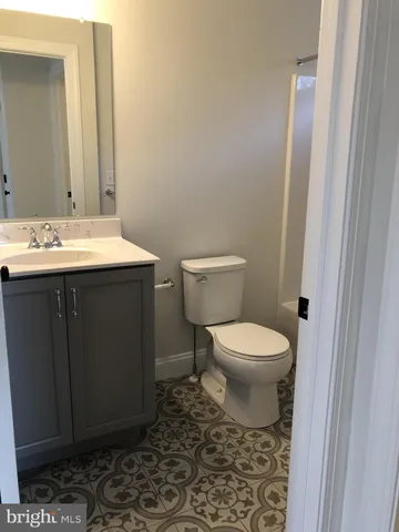 a bathroom with a toilet a sink and a mirror