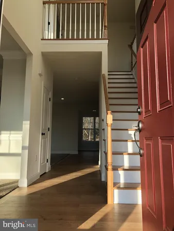 a view of staircase with white walls and windows