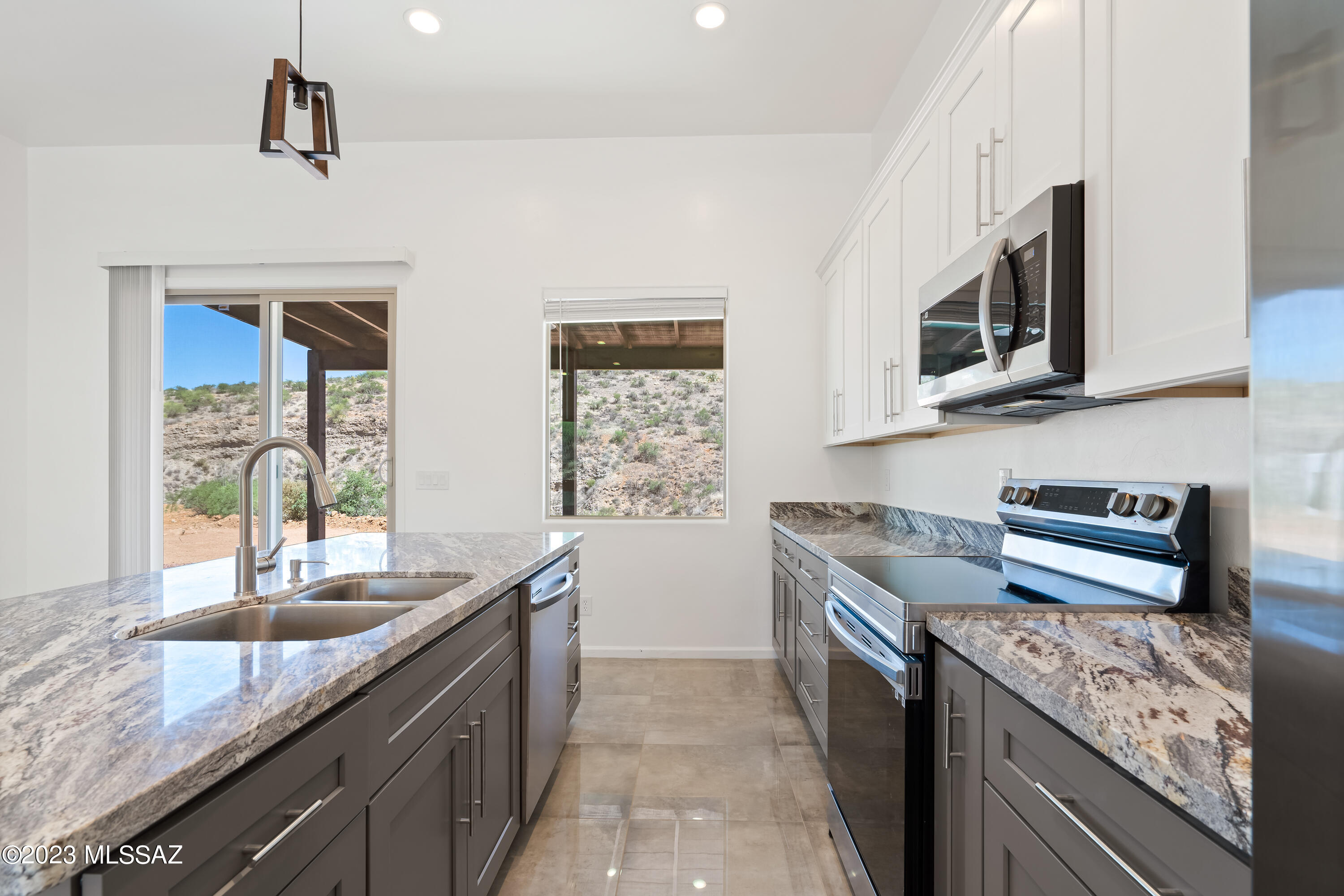 294 Circulo Cerro Rio Rico, AZ 85648 - Photo 13 of 38 a kitchen with stainless steel appliances granite countertop a sink stove and cabinets
