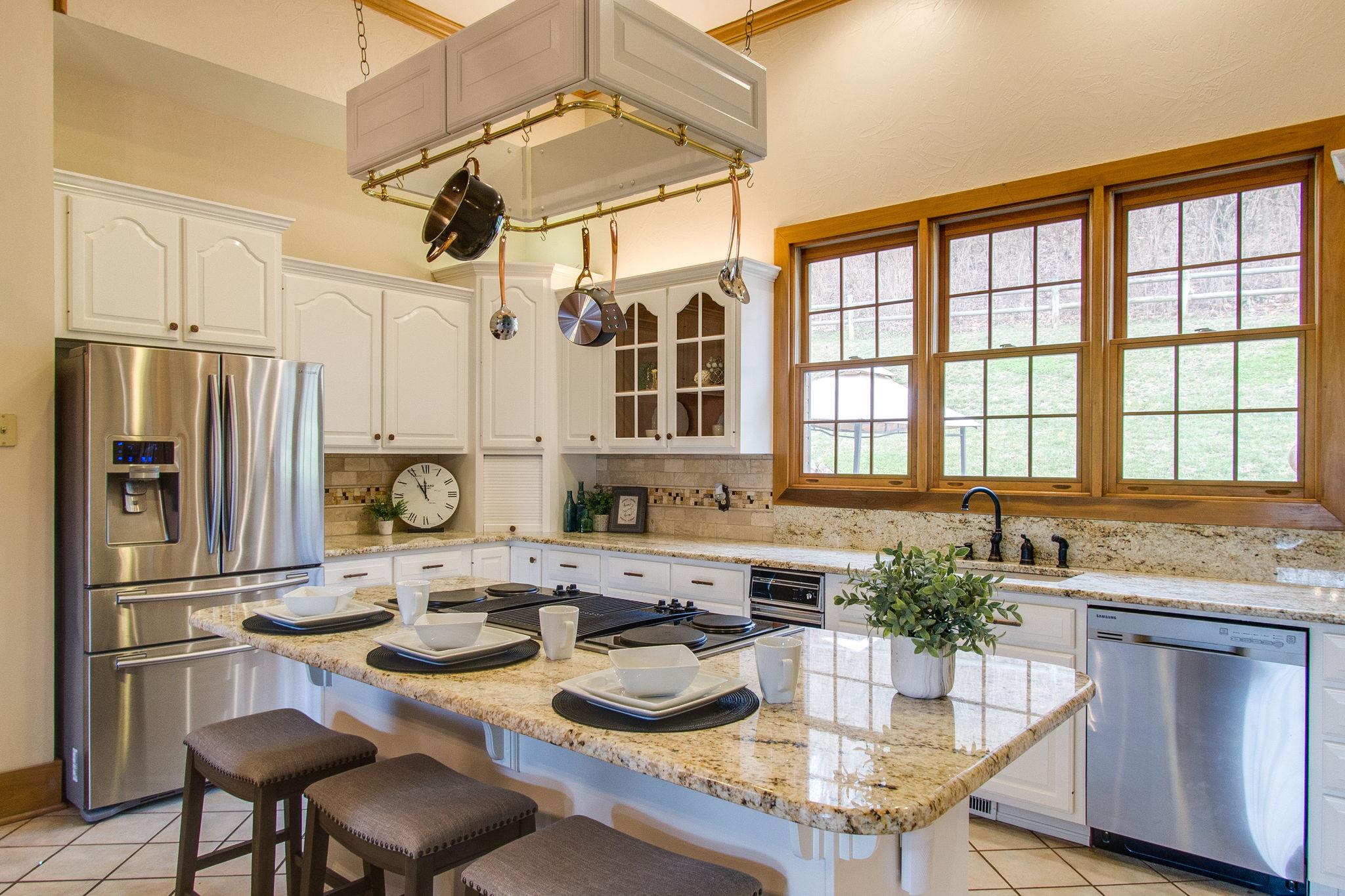 1026 Holly Tree Gap Road Brentwood, TN 37027 - Photo 11 of 27 a kitchen with sink refrigerator dining table and chairs