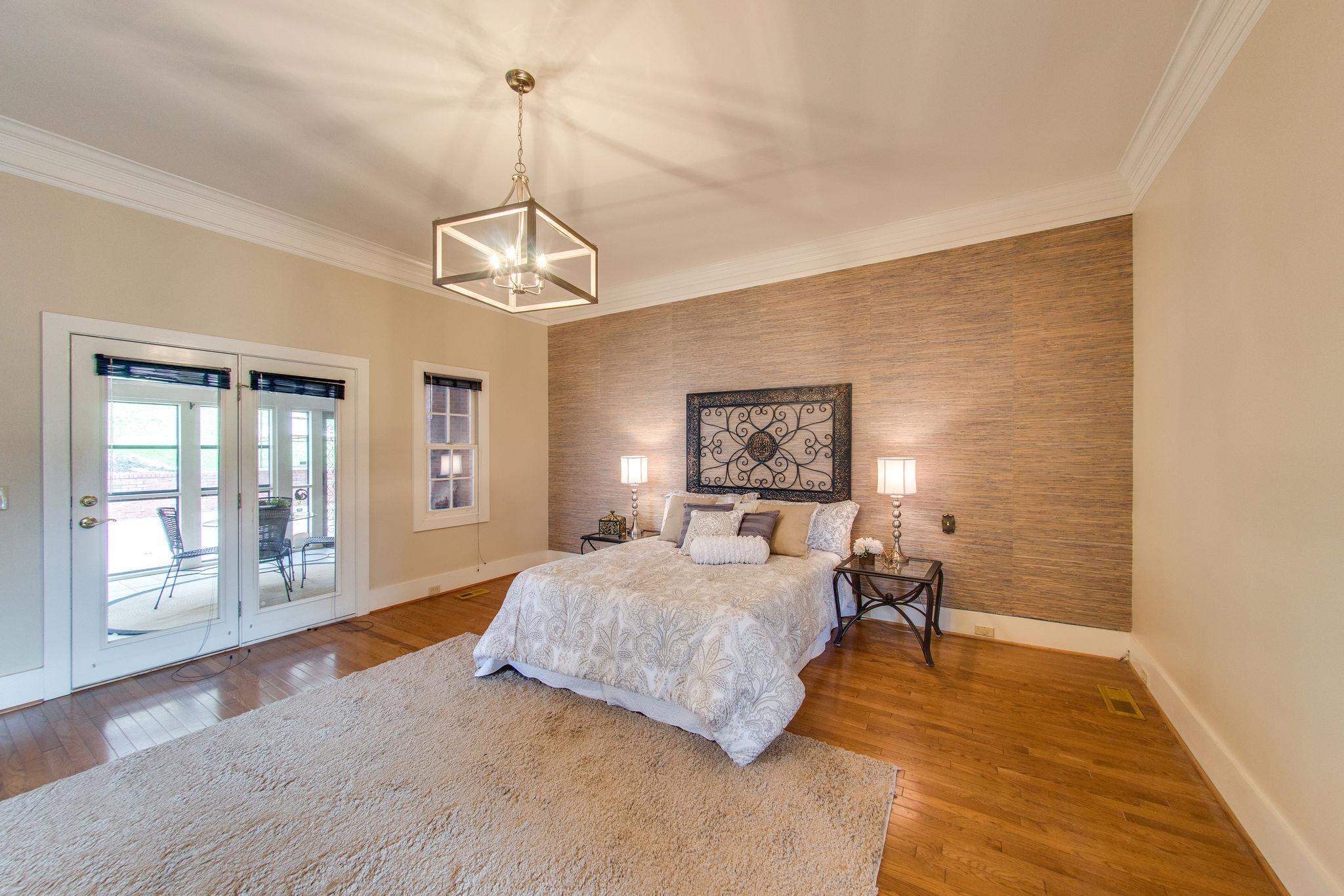 1026 Holly Tree Gap Road Brentwood, TN 37027 - Photo 15 of 27 a bedroom with a bed and wooden floor