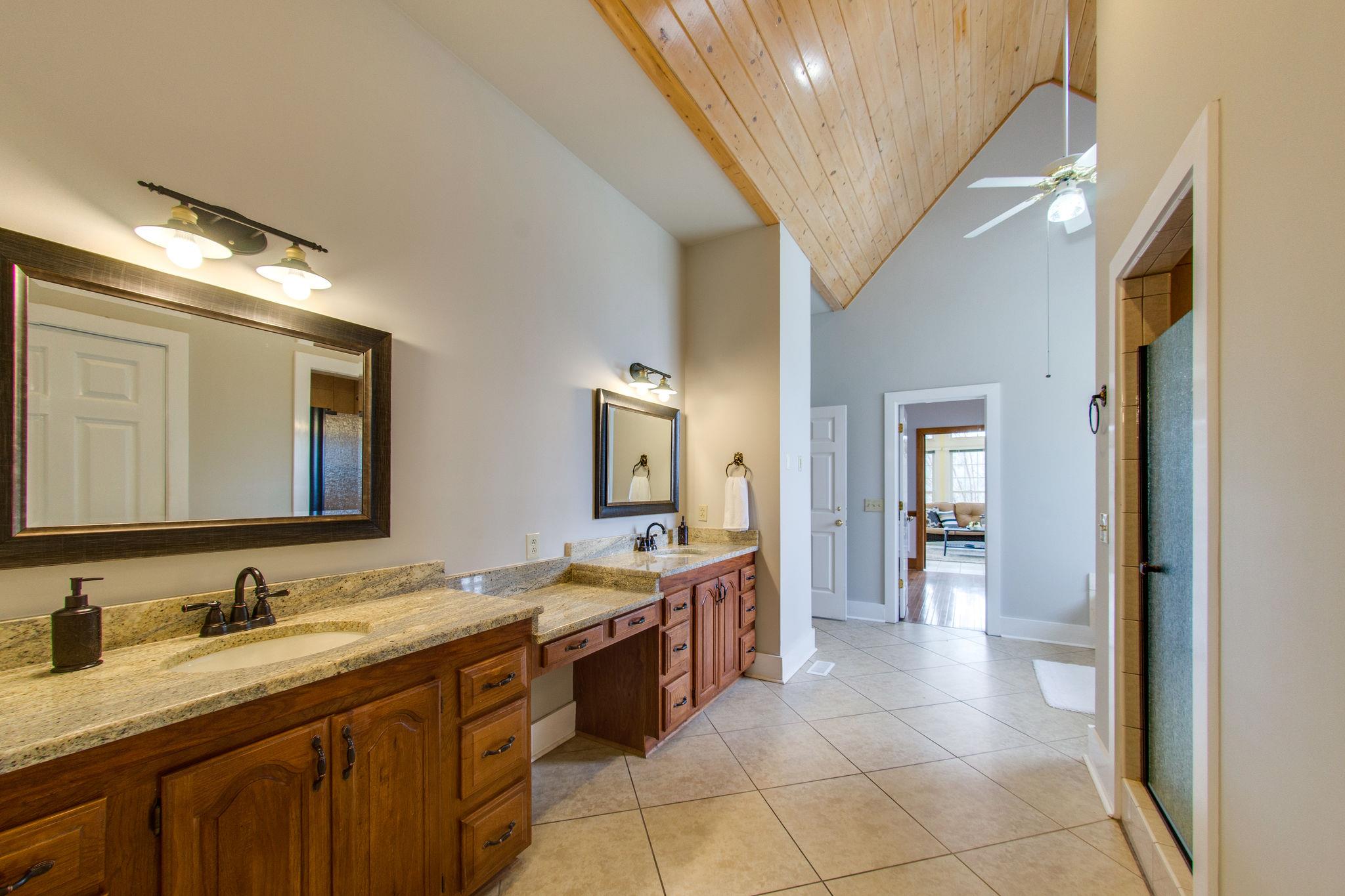 1026 Holly Tree Gap Road Brentwood, TN 37027 - Photo 16 of 27 a spacious bathroom with a granite countertop sink a mirror and a