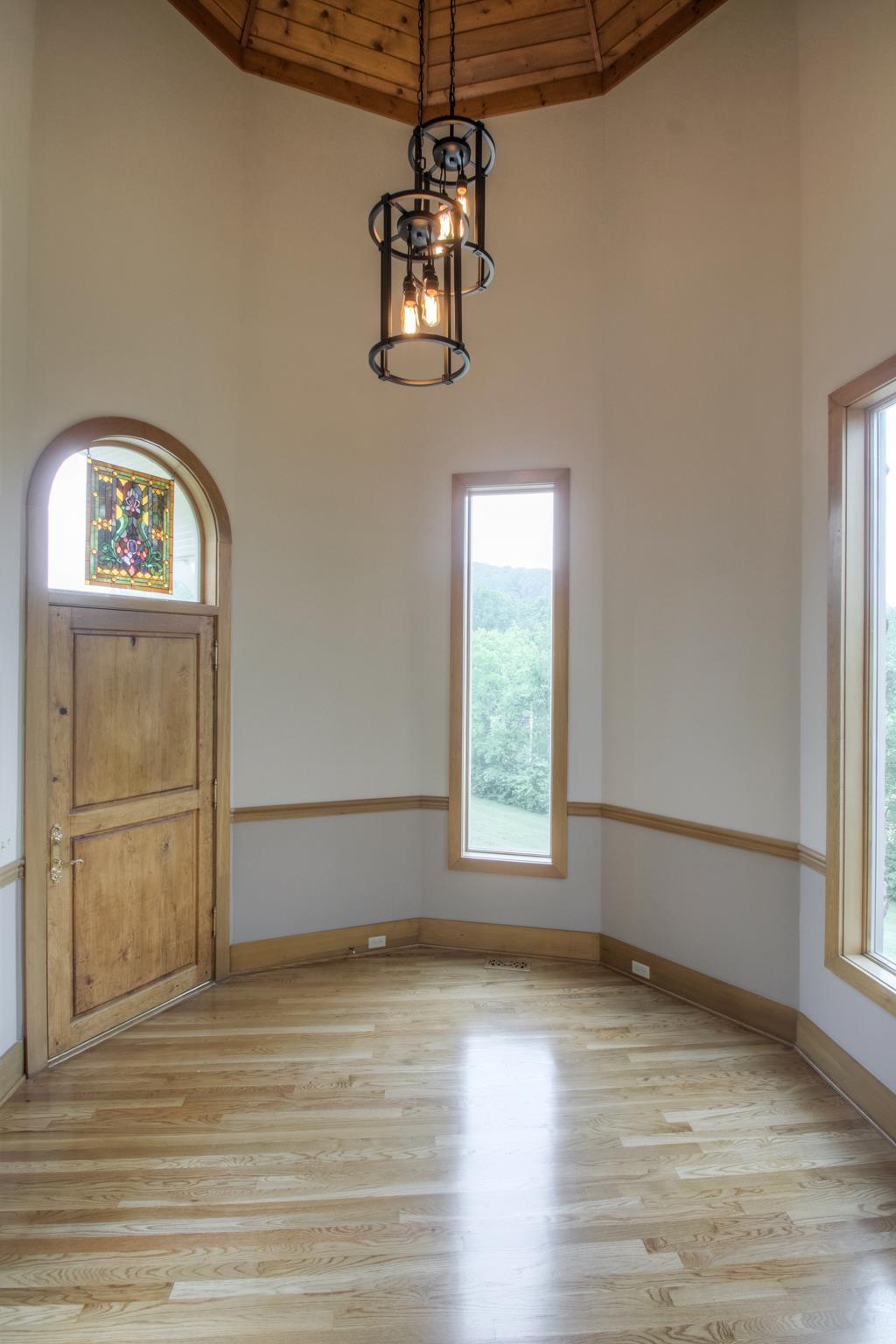1026 Holly Tree Gap Road Brentwood, TN 37027 - Photo 7 of 27 an empty room with wooden floor cabinet and windows