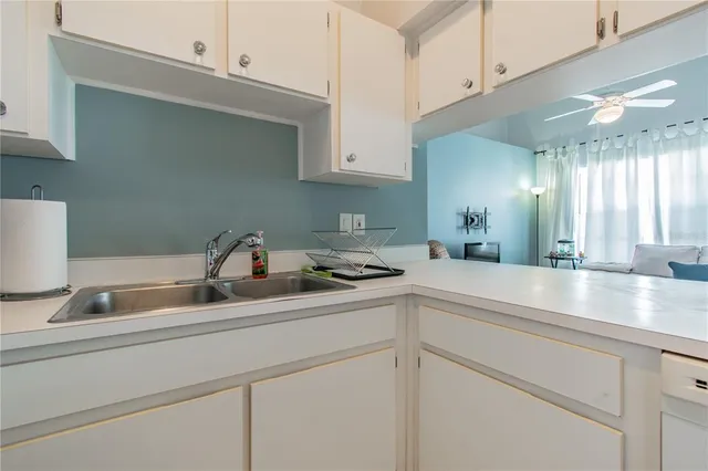 a kitchen with stainless steel appliances granite countertop a sink a stove and cabinets