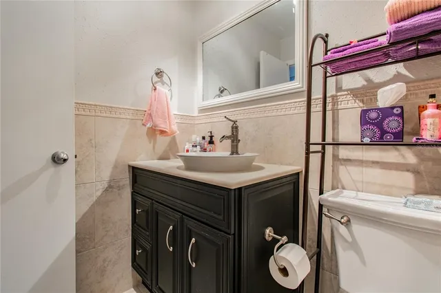 a bathroom with a sink vanity and toilet
