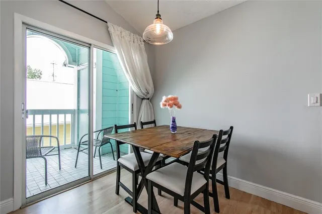 a view of a dining room with furniture wooden floor and chandelier