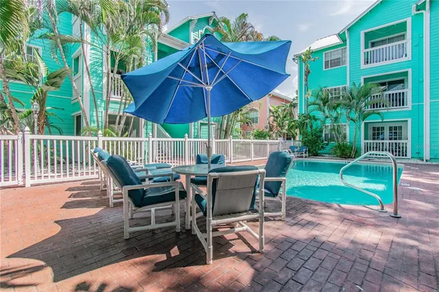 a view of a chair and table in the backyard