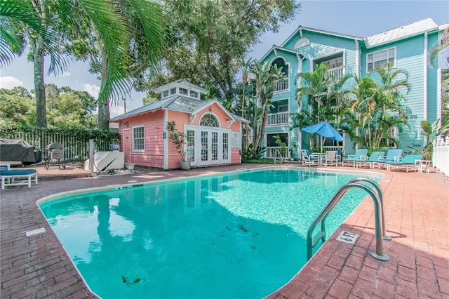 a front view of a house with swimming pool having outdoor seating