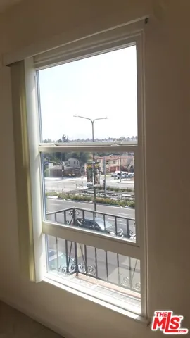 a view of a glass door with a view of the balcony