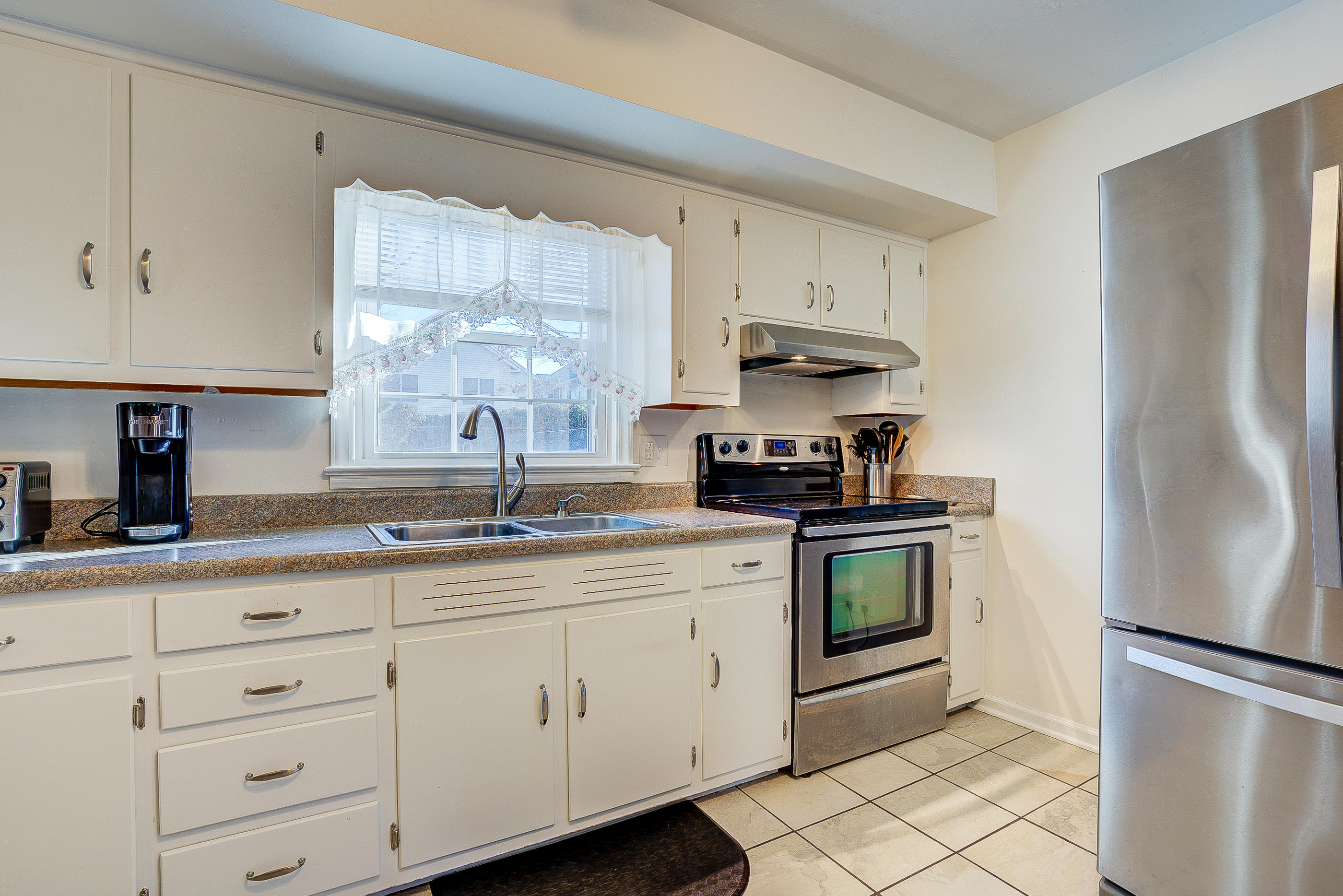 1905 Burma Road Salem, VA 24153 - Photo 11 of 26 a kitchen with white cabinets and white stainless steel appliances