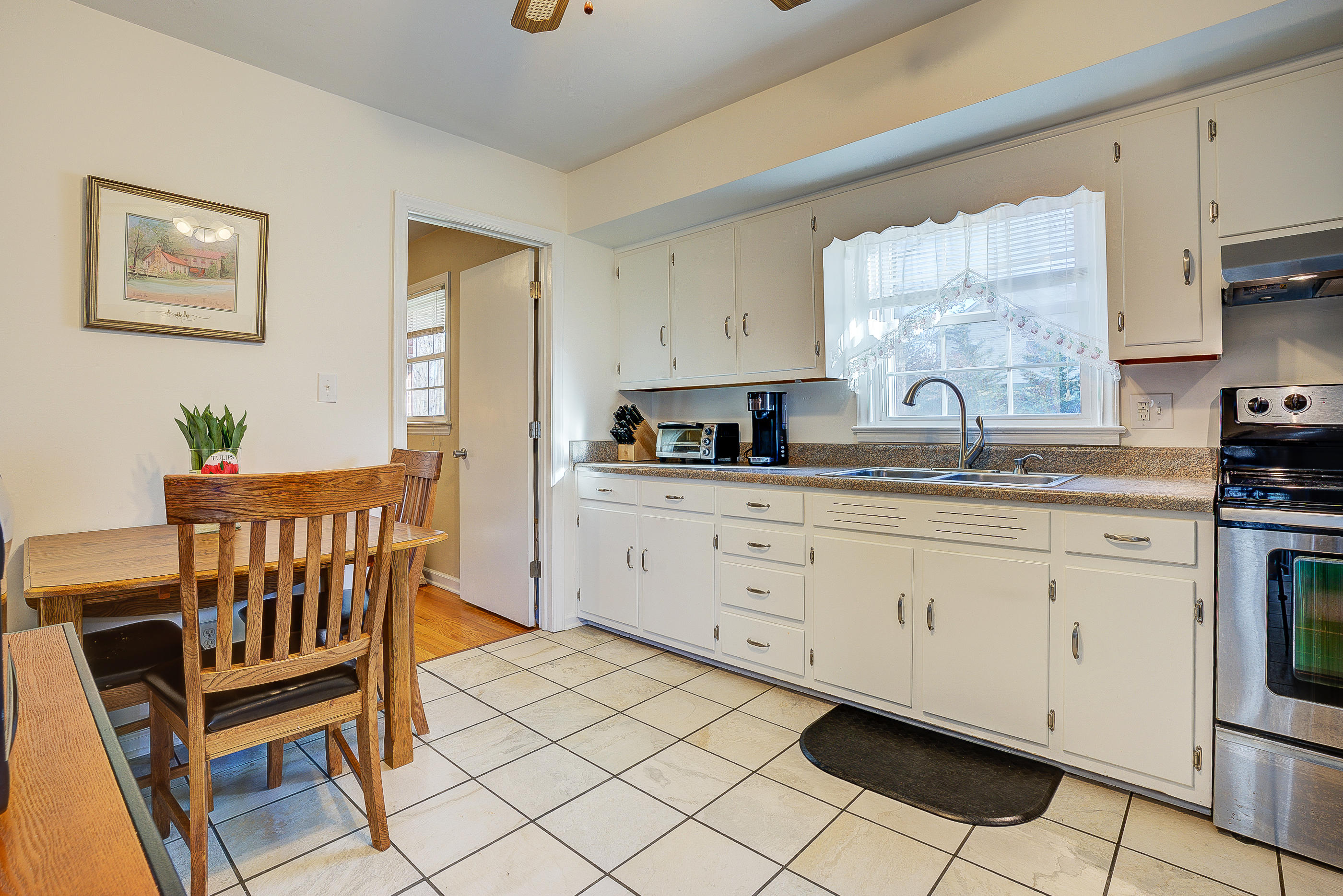 1905 Burma Road Salem, VA 24153 - Photo 8 of 26 a kitchen with granite countertop white cabinets and white appliances