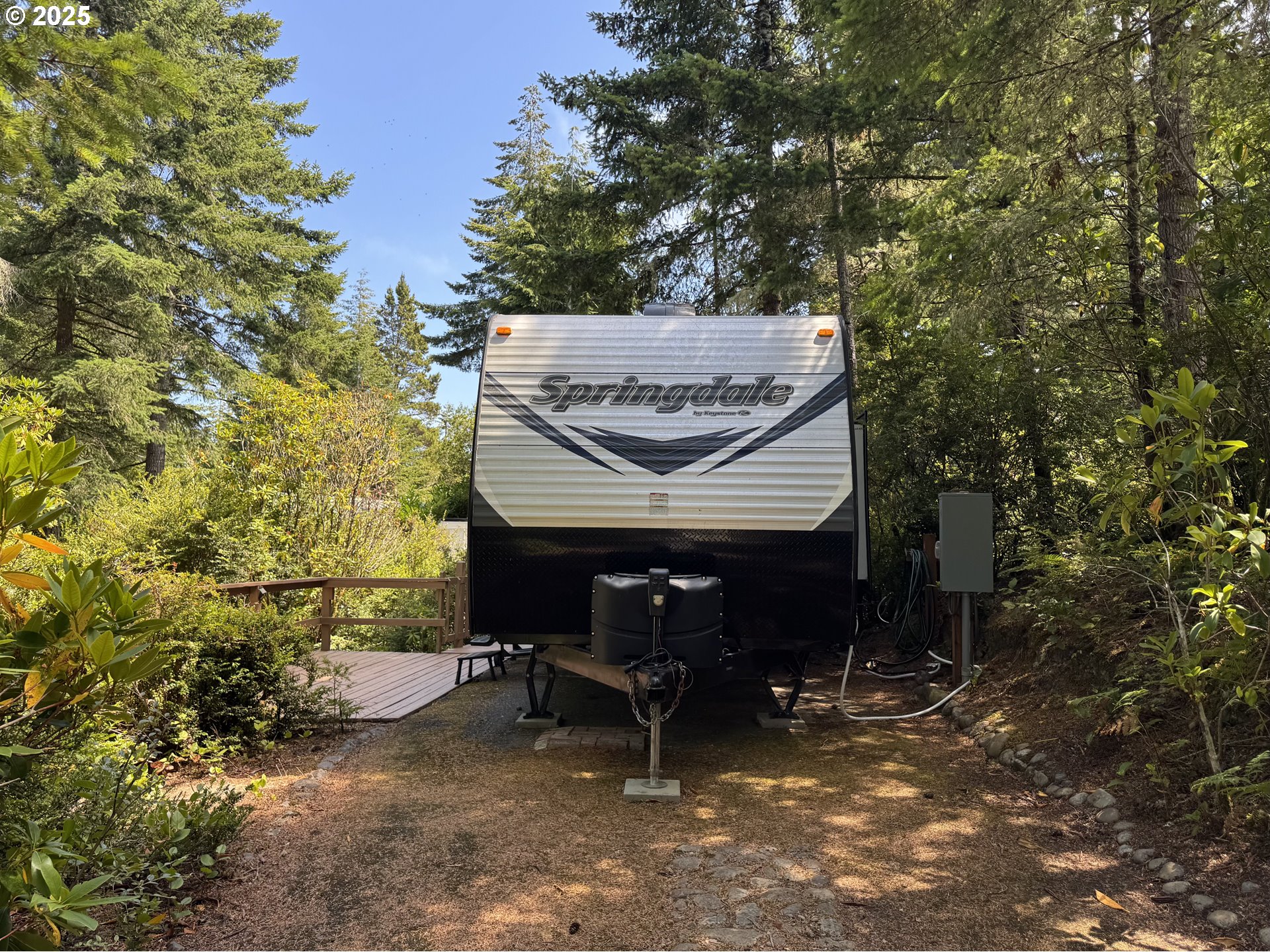 a view of a patio with table and chairs with wooden fence and plants