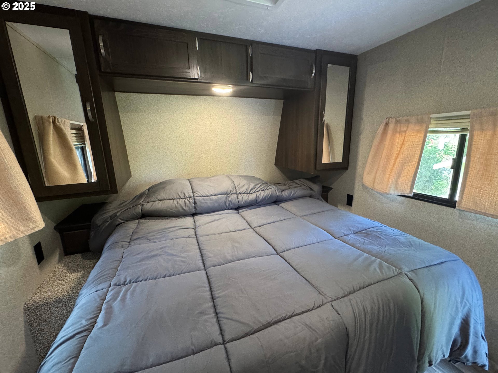 248 Horseshoe Bend Florence, OR 97439 - Photo 19 of 32 a bedroom with a bed and a mirror