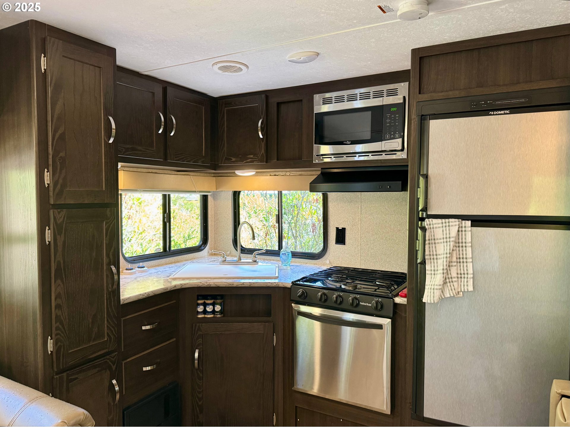 248 Horseshoe Bend Florence, OR 97439 - Photo 22 of 32 a kitchen with granite countertop a refrigerator stove and microwave