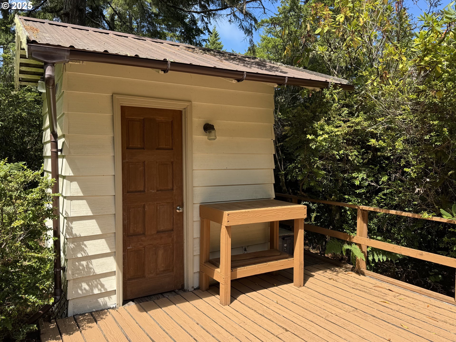 248 Horseshoe Bend Florence, OR 97439 - Photo 8 of 32 a balcony with wooden floor and bench