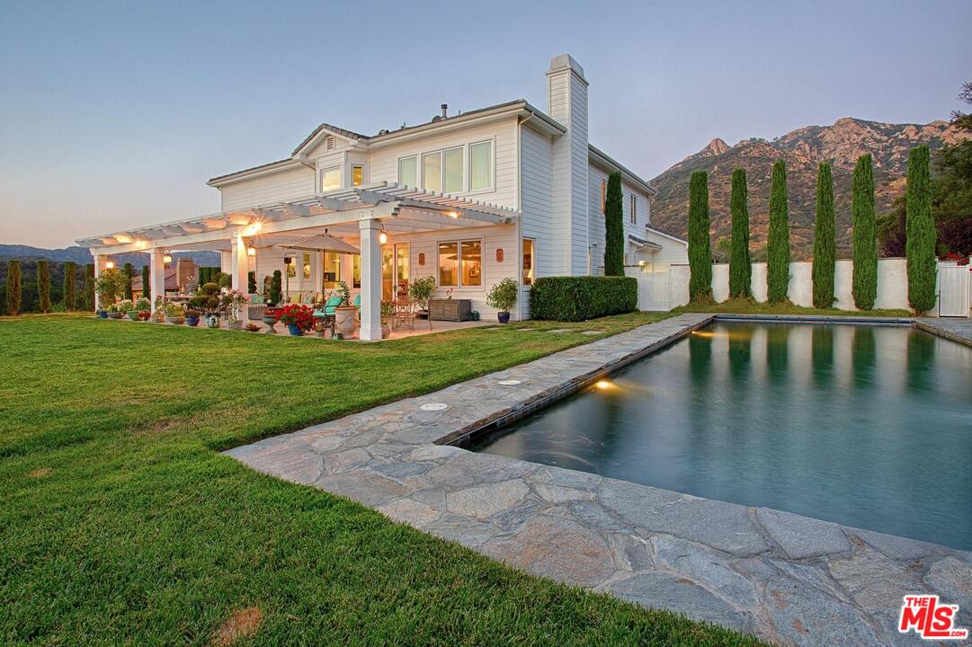 423 Woodbluff Road Monte Nido, CA 91302 - Photo 1 of 31 a view of a house with a yard