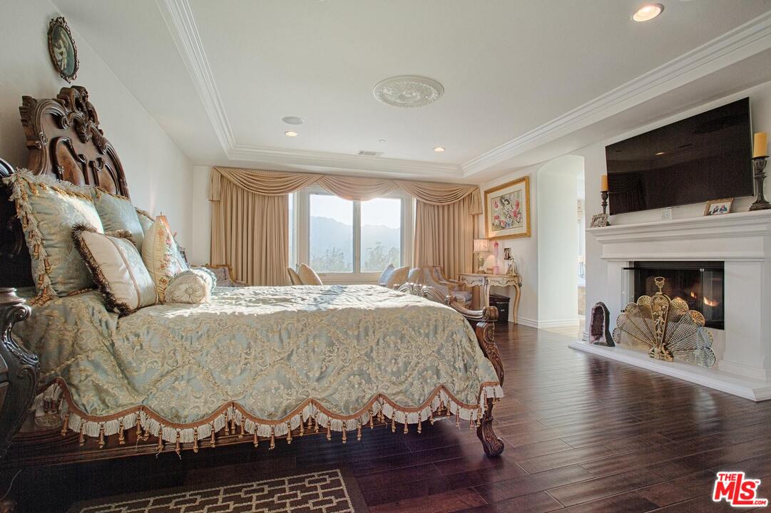 423 Woodbluff Road Monte Nido, CA 91302 - Photo 17 of 31 a living room with furniture fireplace and flat screen tv